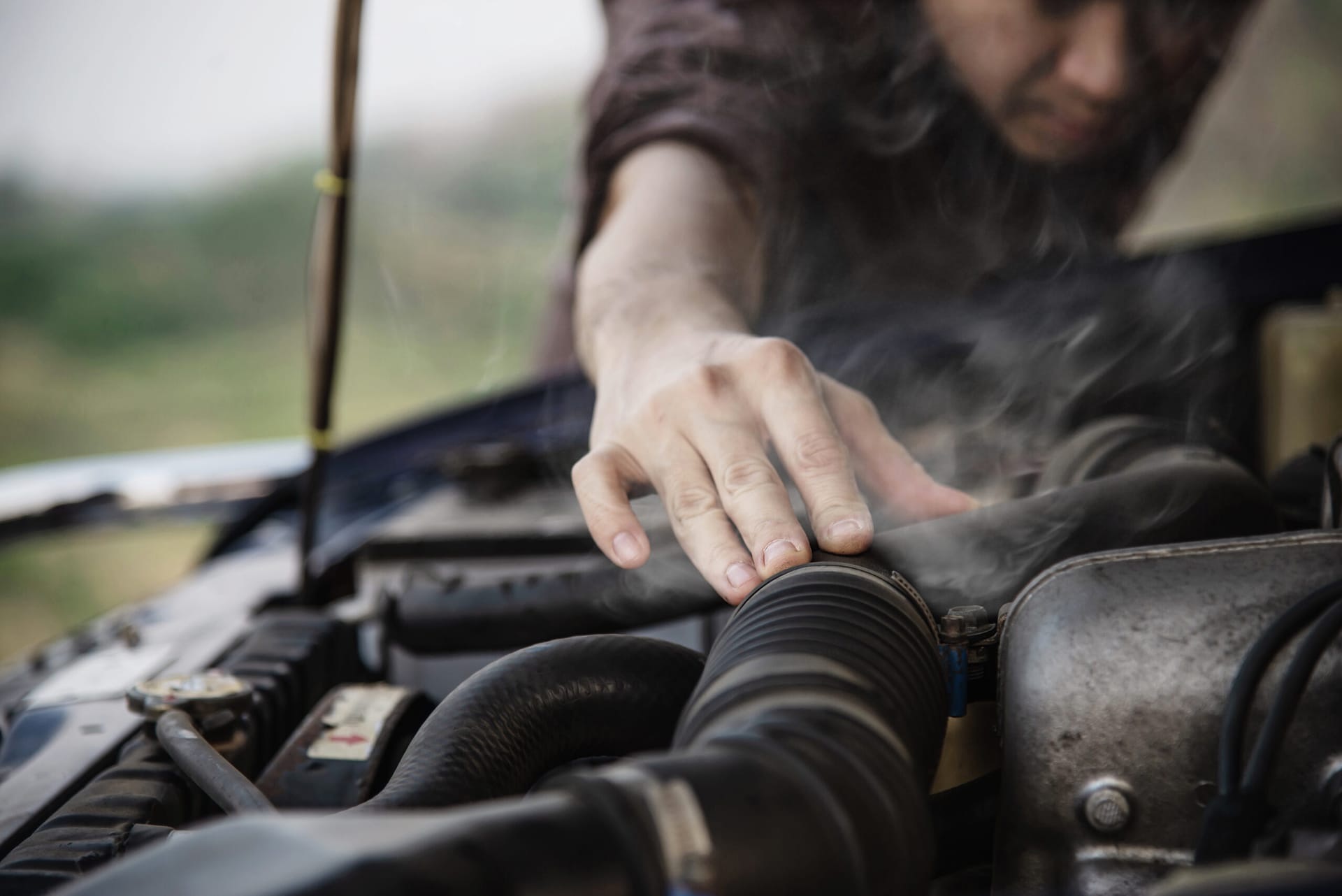 Man try to fix a car engine problem on a local road Chiang mai Thailand - people with car problem transportation concept